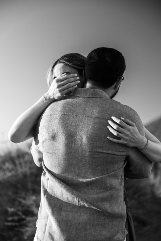 Hug after proposal photography in santorini